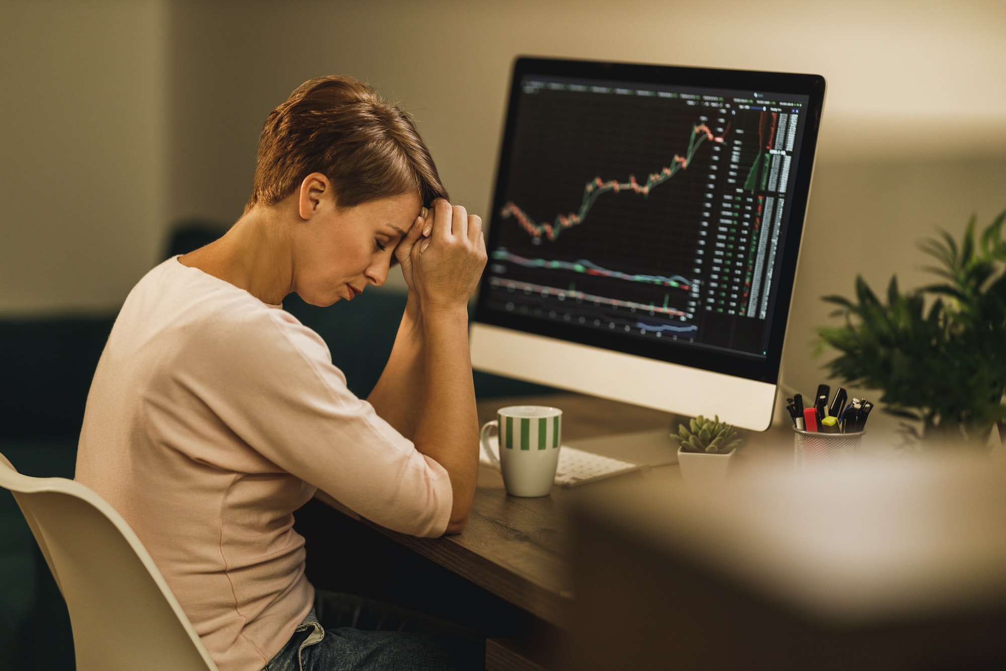 Woman Experiencing Stress During A Late Night Analyzing Crypto Graph From Home